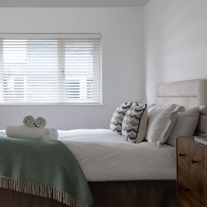 Cushions and towels on bed